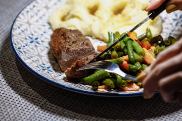Potatoes with meat and vegetables on the table