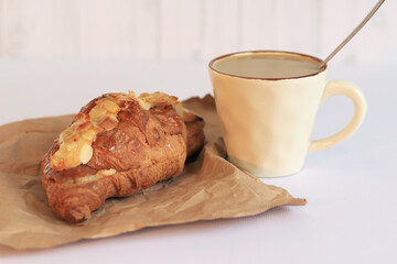 Coffee with croissants. Hot coffee and french croissant on light background