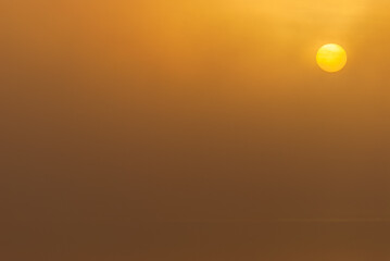 Sunrise at misty and still lake