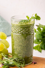 Smoothies of microgreens in a glass glass cup.