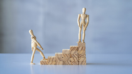 Wooden block and wooden puppet walking up stairs with puppet standing waiting business success...