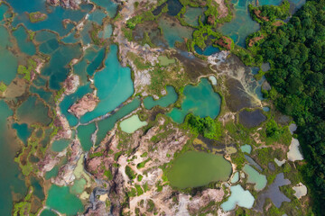 Aerial view of a small laterite mountain with a lots of small lake that reflect the sky colour.