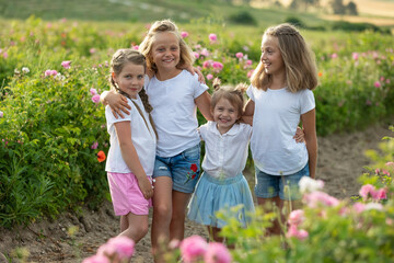Fototapeta premium Children play in nature. The girls are having fun running around.
