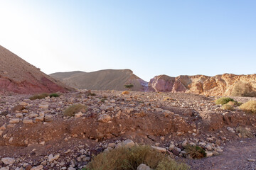 Fantastically beautiful landscape in the national nature reserve - Red Canyon in the rays of the setting sun, near the city of Eilat, in southern Israel