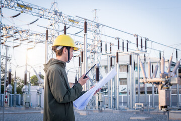 Electrical engineer standing at the power substation