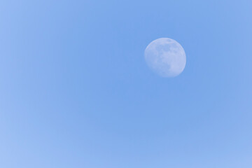 view on waxing gibbous Moon in a blue sky