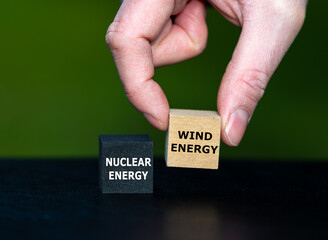 Hand selects cube with the expression 'wind energy' instead of the cube with the text 'nuclear...