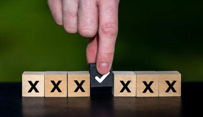 Hand selects a black cube. Symbol for making an decision.