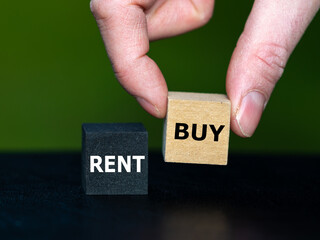Hand selects the cube with the word buy instead of the cube with the word buy. Symbol for buying an...