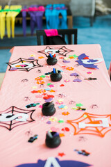 halloween decorations set out on kids crafts table at party