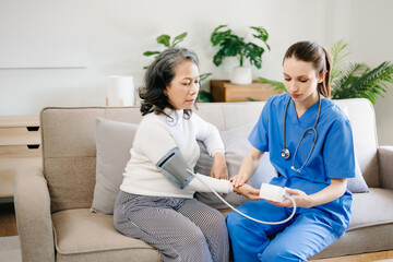 Fototapeta premium Asian female hands touching old female hand Helping hands take care of the elderly concept in hospital.