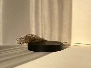 Beige scene for product presentation, black podium with copy space.Natural pedestal with a...