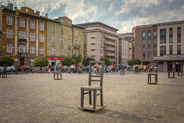 Ghetto heroes square with lots of symbolic chairs in Krakow, Poland - obrazy, fototapety, plakaty