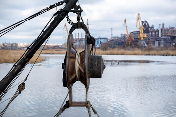ship equipment against the background of the destroyed Azovstal plant in Ukraine
