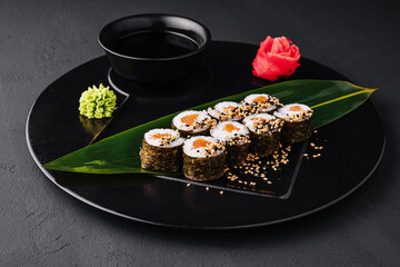 Sushi Rolls Set with Salmon on black plate