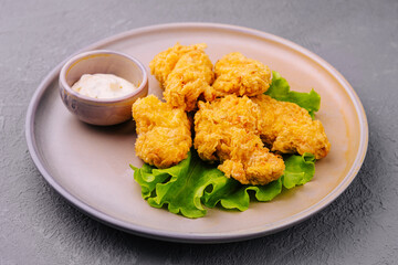 Delicious crispy fried chicken breast strips with sauce