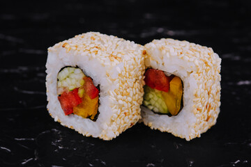 vegan sushi rolls with sesame seeds, peppers and cucumbers