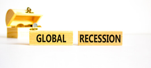 Global recession symbol. Concept words Global recession on wooden blocks. Beautiful white table white background. Wooden chest with coins. Business and global recession concept. Copy space.