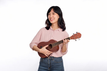 Happy young asian woman with casual clothing playing ukulele isolated on white background