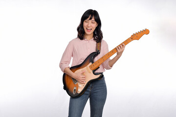 Fototapeta premium Asian woman playing a vintage sunburst electric guitar isolated on white background