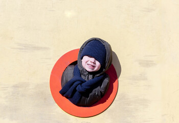 kids brothers are having fun in park with pigeons at playground sunny winter cold day big colorful...