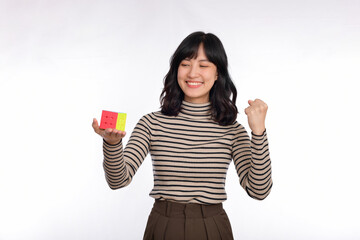 Asian woman holding a rubik cube standing on white background. solving cubic problems, problem...