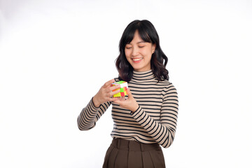 Asian woman holding a rubik cube standing on white background. solving cubic problems, problem...