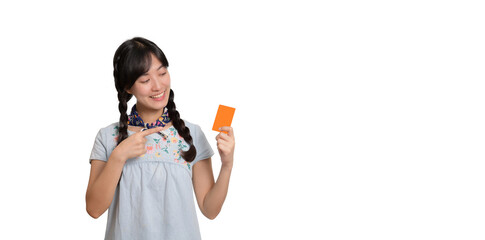 Portrait of beautiful happy young asian woman in denim dress holding credit card on white background