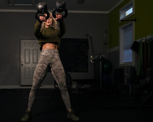Woman doing a double kettlebell swing.