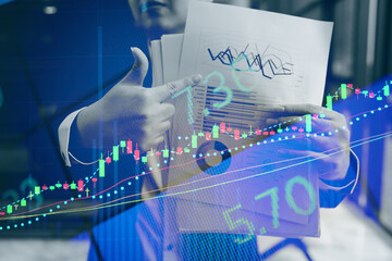 Double exposure of young business man and digital number of stock market background to represent successful in investment marketing. Find out the best solution in business and financial as concept.