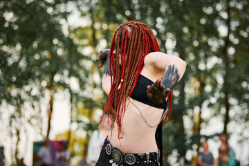 Mythological dancing girl faun on green lawn in public park outdoor art dancing event with...