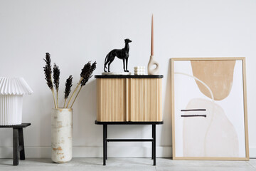 Stylish living room interior design with wooden commode, mock up poster frame and creative accessories and home decor. Modern home staging. Template. Copy space. .