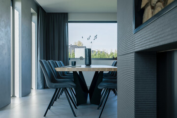 Stylish composition of elegant dining room interior design with velvet armchairs, design rectangle wooden table and beautiful personal accessories. Modern interior design inspiration. Template.