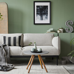 Elegant living room interior design with mockup poster frame, modern grey sofa, wooden commode, folding screen, plants and stylish accessories. Eucalyptus wall. Template. Copy space.