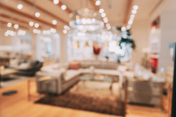 Home accessories and household products in store of shopping centre. View of home accessories for living room in shop fashion retail store. Sofa with pillows. Abstract blur blurred boke bokeh
