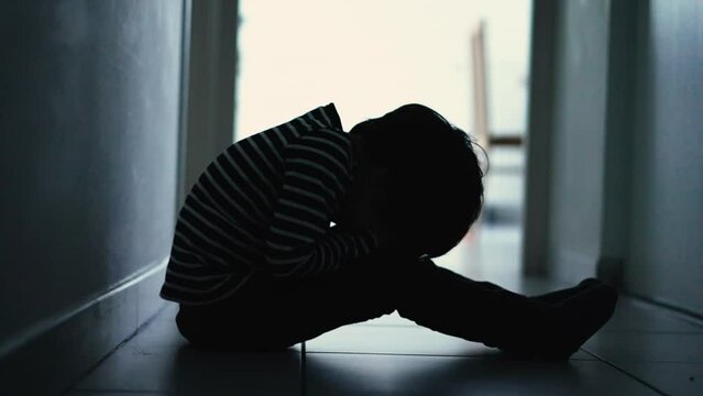 One lonely little boy sitting at home alone feeling upset unhappy child waiting for parents. Child thinking about problems suffering from bad relationship in family. Psychological trauma concept