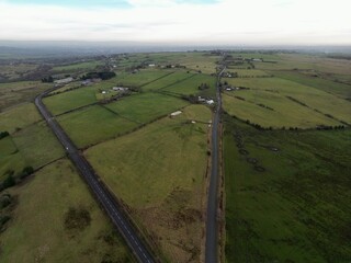 Aerial view of a country road surrounded by farmland and fields. Taken in Bury Lancashire England. 