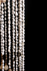 Beautiful seashells beads for door decoration on black background