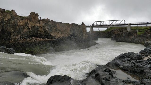 Wild river flowing under bridge downstream of Godafoss waterfalls near Akureyri, Iceland
