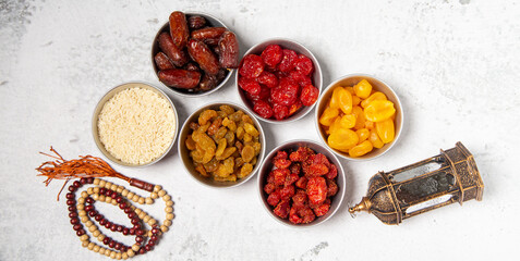 Concept: Ramadan food Sweets mixed of dried fruits , Dates premium dates, 
full of date fruits, Arabic coffee, Concept: month fasting culture Muslim prayer, 
1444 Puasa Ramadan Kareem greeting festiva