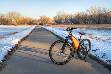mountain bike on Poudre River Trail near Windsor in Colorado, winter scenery