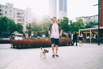 Young male with dog on city street