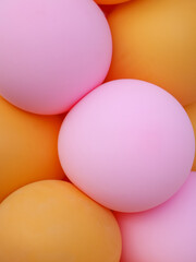 Pink and yellow balloons of a round geometric shape