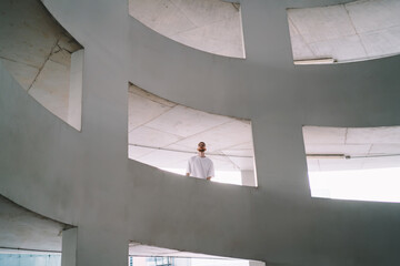 Unrecognizable man standing in parking building