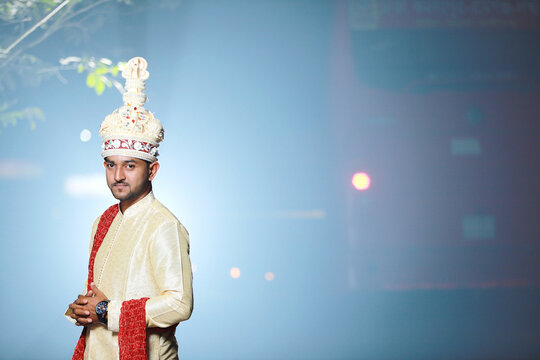 Hindu religious young handsome groom in outdoor wedding photoshoot 