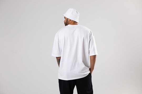 Man in a white t-shirt and panama. Mock-up. Back view.