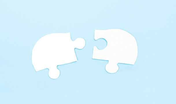 On a light blue background there are two white puzzles with a place to insert text