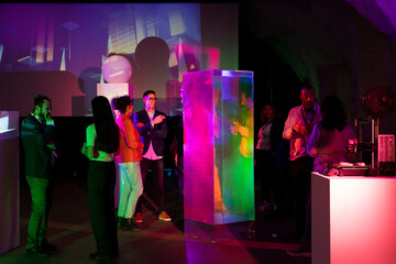 Multiracial female and male entrepreneurs discussing strategy in conference event at exhibition center