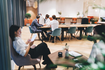 Group of colleagues taking selfie while working on project in cafe