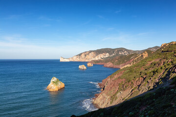 Fototapeta na wymiar Rocky Cliffs on the Sea Coast. Sardinia, Italy. Nature Background